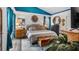 Well-lit bedroom with a comfortable bed, a bench, and cool-toned accents at 1130 Woodsong Way, Clermont, FL 34714