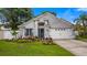 Beautiful single-Gathering home with a lush front yard, a two-car garage, and a welcoming entrance at 1130 Woodsong Way, Clermont, FL 34714