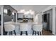 Stylish kitchen island with granite countertop, pendant lights, and stainless steel appliances at 1130 Woodsong Way, Clermont, FL 34714