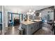Stylish kitchen featuring a large island, modern appliances, and seamless flow to the living area at 1130 Woodsong Way, Clermont, FL 34714