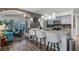 Open-concept kitchen featuring an island with seating, stainless steel appliances, and stylish decor at 1130 Woodsong Way, Clermont, FL 34714