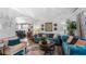 Stylish living room features a blue sofa, area rug, and decor at 1130 Woodsong Way, Clermont, FL 34714