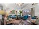 Inviting living room with vaulted ceiling, a ceiling fan, and sliding glass doors to the outdoors at 1130 Woodsong Way, Clermont, FL 34714