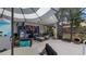Screened patio with outdoor seating, ceiling fan, and view of the backyard at 1130 Woodsong Way, Clermont, FL 34714