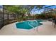 Screened-in pool with well-maintained landscaping and surrounding concrete deck at 1130 Woodsong Way, Clermont, FL 34714