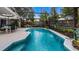 Sparkling pool inside of screened lanai and dining and lounge seating at 1130 Woodsong Way, Clermont, FL 34714