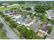 An aerial view of a residential community with a pond, trees, and nearby roadways at 15169 Harrowgate Way, Winter Garden, FL 34787