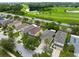 An aerial view of a residential neighborhood bordering a golf course and water feature at 15169 Harrowgate Way, Winter Garden, FL 34787