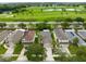 Aerial view of homes, driveways, lawns, and landscaping in a golf community at 15169 Harrowgate Way, Winter Garden, FL 34787