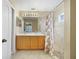 Bathroom featuring a double sink vanity, tile flooring, and a shower enclosed with a floral shower curtain at 15169 Harrowgate Way, Winter Garden, FL 34787