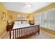 Bright bedroom featuring carpet flooring, a wood bed frame, and a window with shutter style blinds at 15169 Harrowgate Way, Winter Garden, FL 34787
