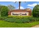 Stone Creek community sign surrounded by colorful landscaping and greenery at 15169 Harrowgate Way, Winter Garden, FL 34787