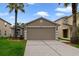 Exterior view of a single-story home with a large garage, lawn, and landscaping at 15169 Harrowgate Way, Winter Garden, FL 34787