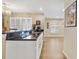 Kitchen features an undermount sink, black countertops, and white cabinets with natural light at 15169 Harrowgate Way, Winter Garden, FL 34787