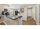 Bright kitchen features dark countertops, white cabinets, and stainless steel appliances at 15169 Harrowgate Way, Winter Garden, FL 34787