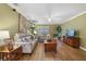 Cozy living room with hardwood floors, neutral furniture, and a TV at 15169 Harrowgate Way, Winter Garden, FL 34787