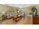Comfortable living room with neutral furniture, a coffee table, and hardwood floors at 15169 Harrowgate Way, Winter Garden, FL 34787