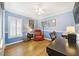 Home office with blue walls, a ceiling fan, and a built in desk with cabinets at 15169 Harrowgate Way, Winter Garden, FL 34787