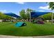 Community playground featuring a blue sunshade, green turf, slides and a climbing structure at 15169 Harrowgate Way, Winter Garden, FL 34787