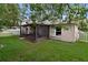 Screened-in patio in the backyard, with white picket fence, well-maintained lawn, and mature trees at 15169 Harrowgate Way, Winter Garden, FL 34787