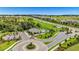 Aerial shot of the community pool, amenity center, and surrounding green spaces near residential homes at 15954 Winding Bluff Dr, Montverde, FL 34756
