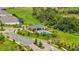 High angle view showcases the community pool and lush green areas with the neighborhood at 15954 Winding Bluff Dr, Montverde, FL 34756