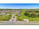 Beautiful aerial view of a residential neighborhood, featuring landscaped streets, green spaces, and community pool at 15954 Winding Bluff Dr, Montverde, FL 34756