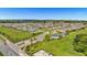 New homes are featured in this aerial view that includes a community pool, sidewalks, and beautifully landscaped yards at 15954 Winding Bluff Dr, Montverde, FL 34756