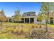 A beautiful backyard with a covered patio, lush green grass, and thoughtfully designed landscaping at 15954 Winding Bluff Dr, Montverde, FL 34756