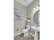 Bathroom features pedestal sink and decorative mirror, a clean, and bright space at 15954 Winding Bluff Dr, Montverde, FL 34756
