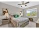 Bright bedroom featuring a ceiling fan, neutral paint, and a large window with a peaceful view at 15954 Winding Bluff Dr, Montverde, FL 34756