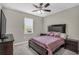 Bedroom featuring a plush bed, window and side tables, creating a tranquil retreat at 15954 Winding Bluff Dr, Montverde, FL 34756