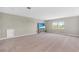 Spacious bonus room featuring neutral carpeting, two windows and a TV entertainment center at 15954 Winding Bluff Dr, Montverde, FL 34756