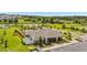 Aerial shot showcases the community center with lush landscaping, park areas, and walking trails at 15954 Winding Bluff Dr, Montverde, FL 34756