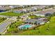 Aerial view of the community pool and amenity center surrounded by neighborhood homes and lush greenery at 15954 Winding Bluff Dr, Montverde, FL 34756