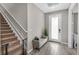 Inviting entryway featuring wood-look tile flooring, a bench seat, and a frosted glass front door at 15954 Winding Bluff Dr, Montverde, FL 34756