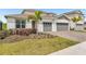 Charming home with a two-car garage, landscaped front yard, and a well-maintained driveway at 15954 Winding Bluff Dr, Montverde, FL 34756
