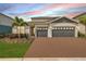 Charming one-story home featuring a two-car garage, brick driveway, and well-maintained landscaping at 15954 Winding Bluff Dr, Montverde, FL 34756