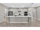 Modern kitchen with white cabinets, quartz countertops, stainless steel appliances, and wood-look tile flooring at 15954 Winding Bluff Dr, Montverde, FL 34756