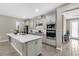 Well-lit kitchen featuring stainless steel appliances, a center island with a sink, and plenty of counter space at 15954 Winding Bluff Dr, Montverde, FL 34756