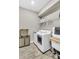 Well-equipped laundry room, complete with modern appliances, storage and a sink, for efficient chores at 15954 Winding Bluff Dr, Montverde, FL 34756