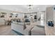 Open-concept layout connecting the living room, dining area, and kitchen, with wood-look tile floors throughout at 15954 Winding Bluff Dr, Montverde, FL 34756