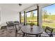 Covered patio boasts brick flooring, comfortable seating, and an open view of the lush green landscape at 15954 Winding Bluff Dr, Montverde, FL 34756