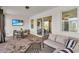 Covered patio with cozy outdoor seating and a TV, perfect for relaxing and enjoying outdoor entertainment at 15954 Winding Bluff Dr, Montverde, FL 34756