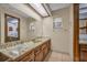 Bathroom featuring a double sink with a patterned countertop and a large mirror at 161 Cindy Ct, Lake Mary, FL 32746