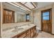 Bathroom with dual vanities, large mirror, and wood accents at 161 Cindy Ct, Lake Mary, FL 32746
