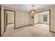 Cozy dining area with an elegant chandelier and doorways into other rooms with large window for natural light at 161 Cindy Ct, Lake Mary, FL 32746
