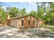 Charming home exterior with stone and wood details and a two-car garage at 161 Cindy Ct, Lake Mary, FL 32746
