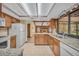 Bright kitchen with granite countertops, wood cabinets, and a view of a cozy fireplace at 161 Cindy Ct, Lake Mary, FL 32746