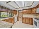 Kitchen with oak cabinets, granite counters, and large window with view to the backyard at 161 Cindy Ct, Lake Mary, FL 32746